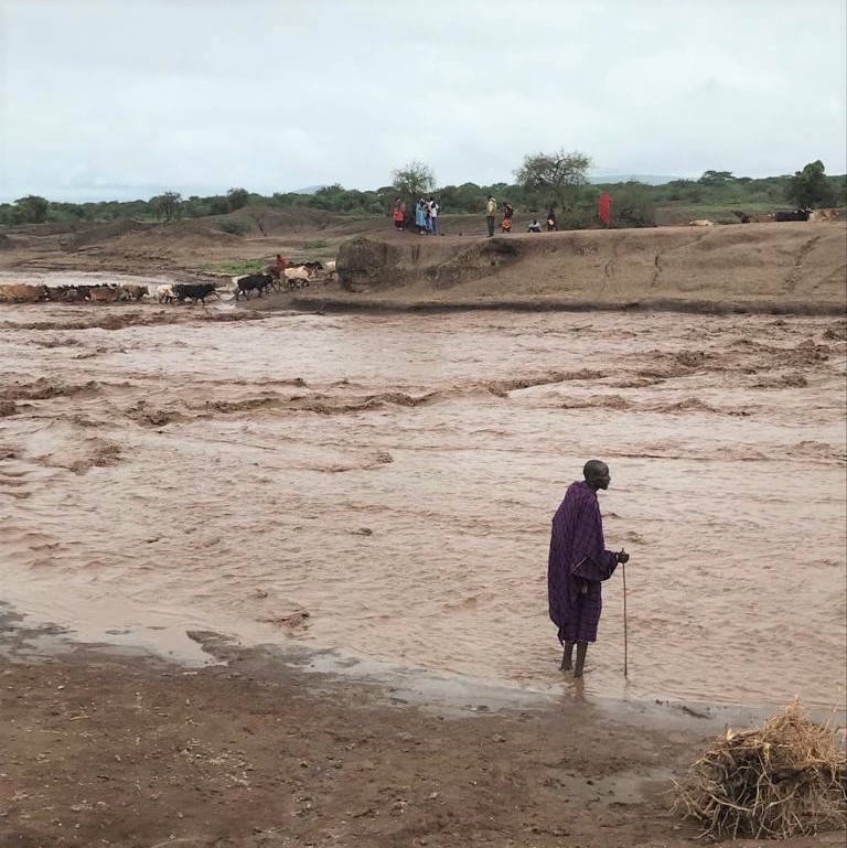 Maasai herder on the flooded Mundarara road, northern Tanzania