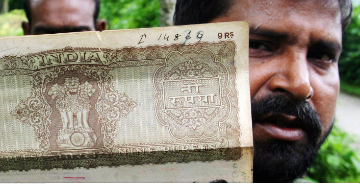 A resident shows a land ownership document issued by Indian authorities at the Dashiarchhara Indian enclave in June 2004